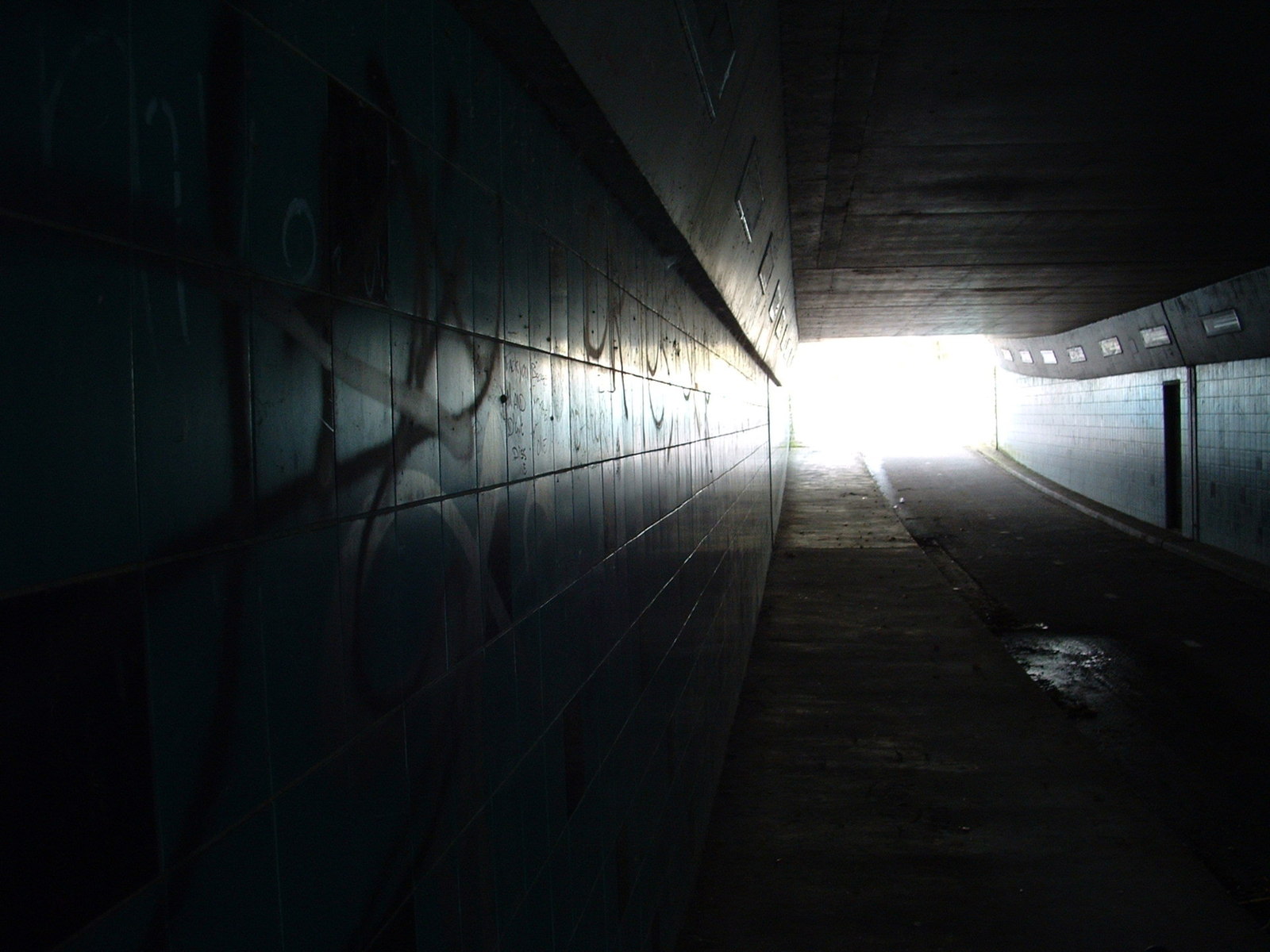 a dark tunnel with light at the end